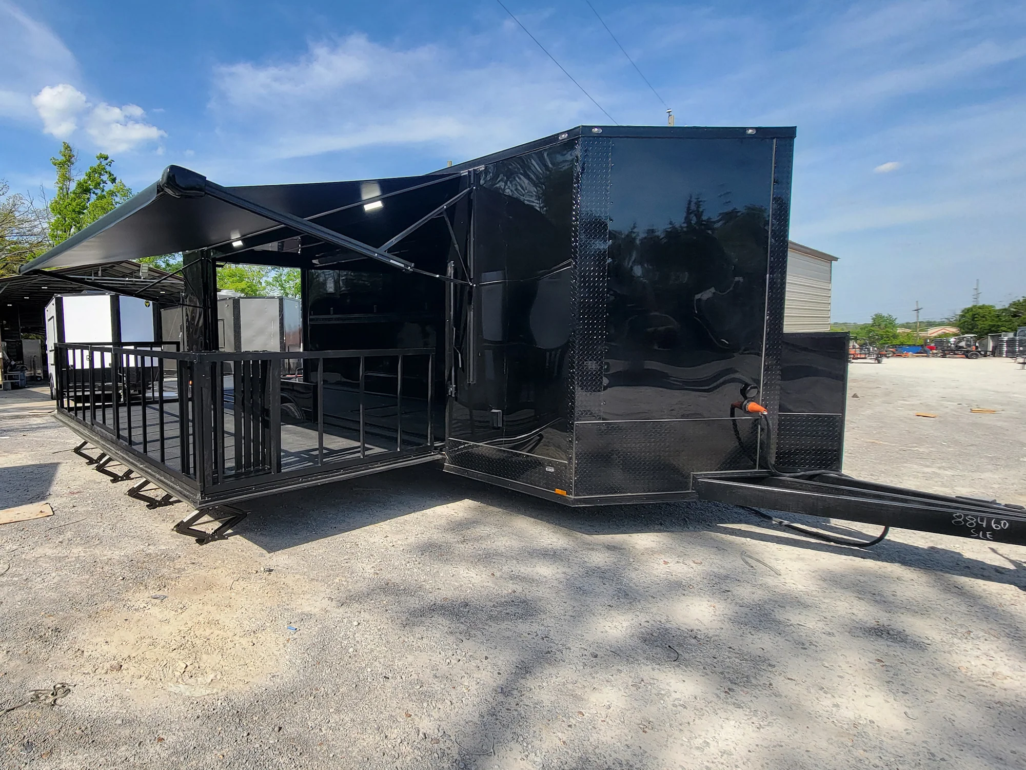 645-8.5-x-24-black-with-blackout-stage-trailer-with-awning-semi-screwless-exterior-1.webp 8.5' X 24' Black With Blackout Stage Trailer With Awning Semi Screwless Exterior