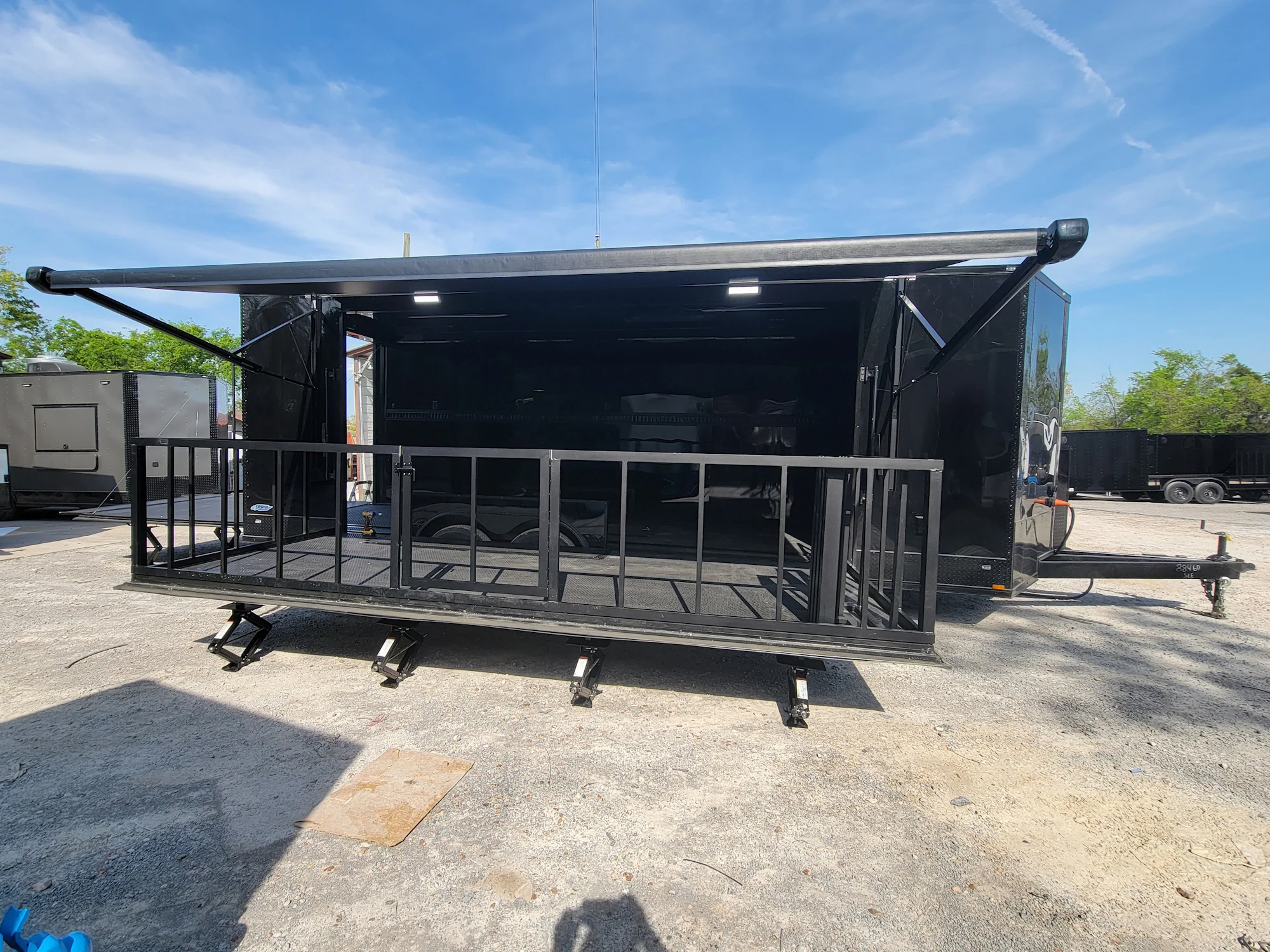 645-8.5-x-24-black-with-blackout-stage-trailer-with-awning-semi-screwless-exterior-4.webp 8.5' X 24' Black With Blackout Stage Trailer With Awning Semi Screwless Exterior