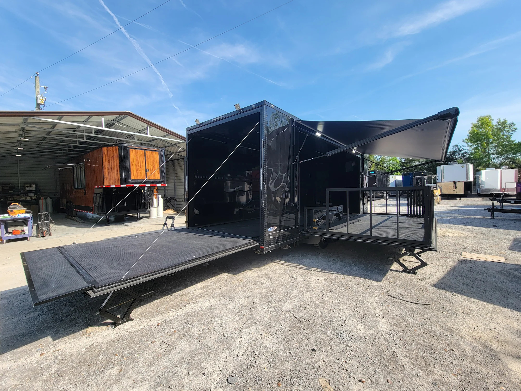 645-8.5-x-24-black-with-blackout-stage-trailer-with-awning-semi-screwless-exterior-6.webp 8.5' X 24' Black With Blackout Stage Trailer With Awning Semi Screwless Exterior